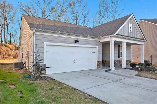 view of front facade featuring board and batten siding, concrete driveway, central AC, stone siding, and an attached garage