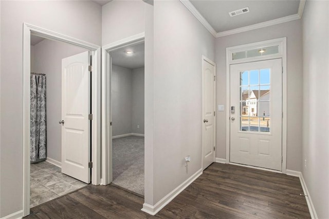 entrance foyer with visible vents, baseboards, dark wood-type flooring, and ornamental molding