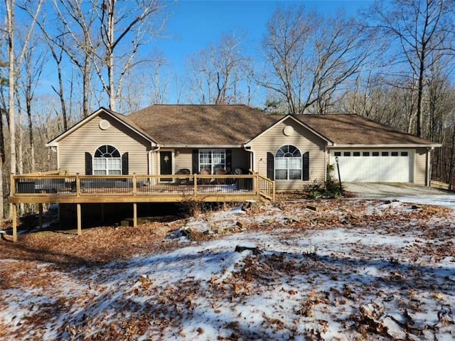 single story home with a garage and a wooden deck