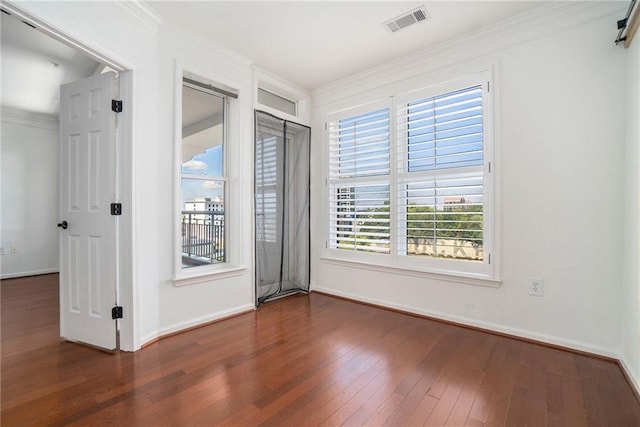 empty room featuring crown molding and dark hardwood / wood-style floors