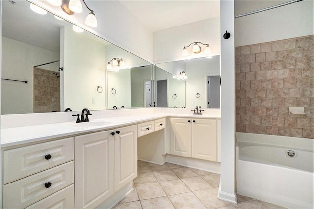 bathroom with tile patterned flooring, vanity, and tiled shower / bath combo