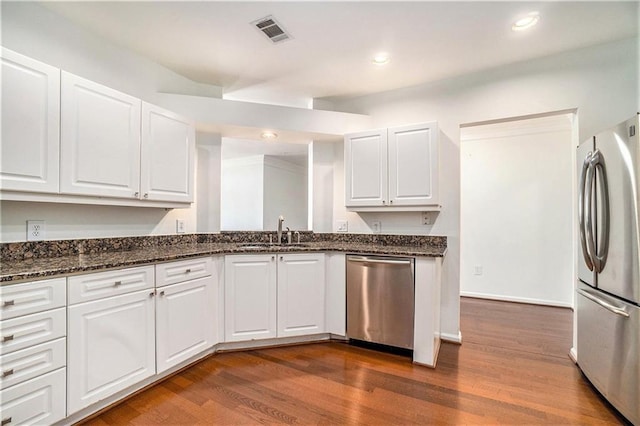 kitchen featuring white cabinetry, dark hardwood / wood-style floors, and appliances with stainless steel finishes