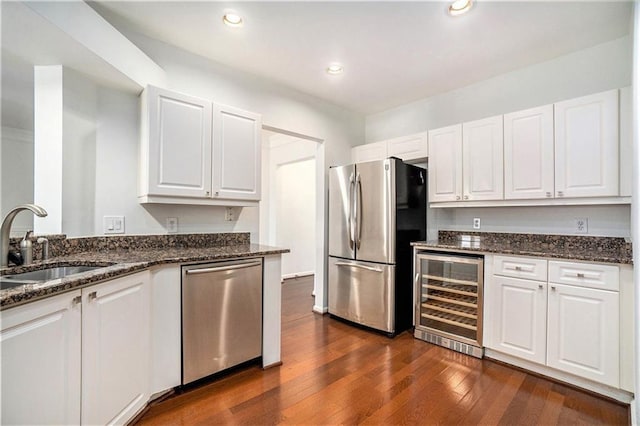 kitchen with white cabinetry, sink, dark wood-type flooring, beverage cooler, and appliances with stainless steel finishes