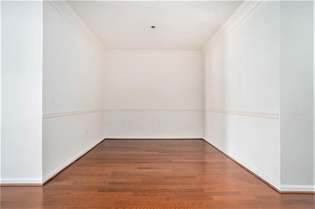 empty room featuring hardwood / wood-style flooring and ornamental molding