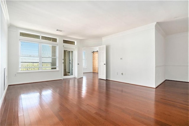 spare room with crown molding and dark hardwood / wood-style flooring