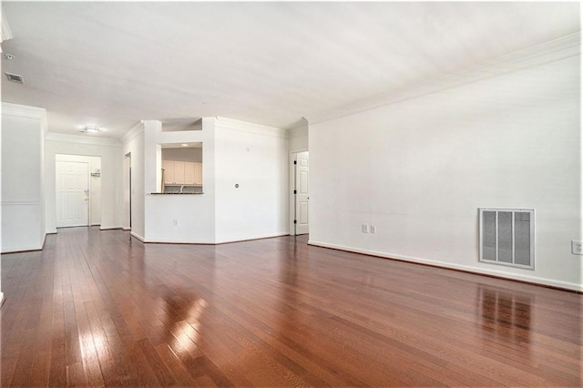 unfurnished living room featuring crown molding and dark wood-type flooring