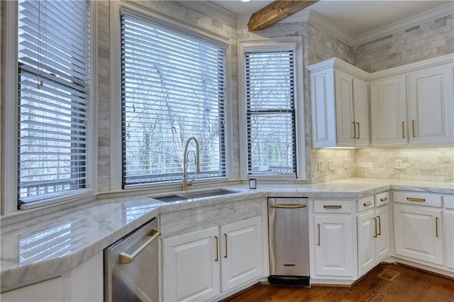 kitchen with crown molding, a healthy amount of sunlight, a sink, and stainless steel dishwasher