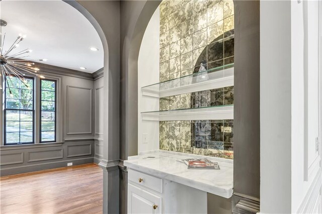 kitchen with stainless steel appliances, dark wood-style flooring, white cabinetry, and beamed ceiling