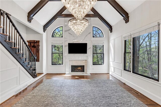 kitchen with crown molding, blue cabinetry, stainless steel appliances, a sink, and wall chimney exhaust hood