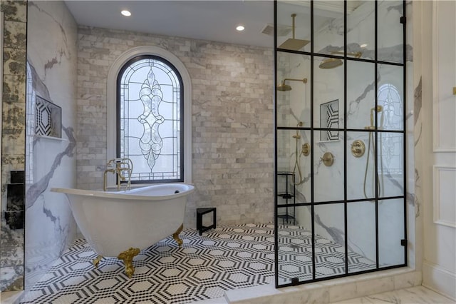 full bathroom with a freestanding tub, a walk in shower, and recessed lighting