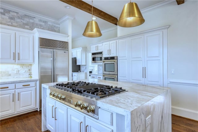 kitchen with appliances with stainless steel finishes, decorative light fixtures, white cabinetry, crown molding, and light stone countertops