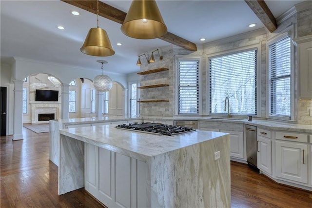 kitchen with a sink, dark wood-style floors, tasteful backsplash, beamed ceiling, and stainless steel gas stovetop