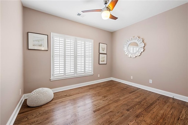 spare room with hardwood / wood-style floors and ceiling fan