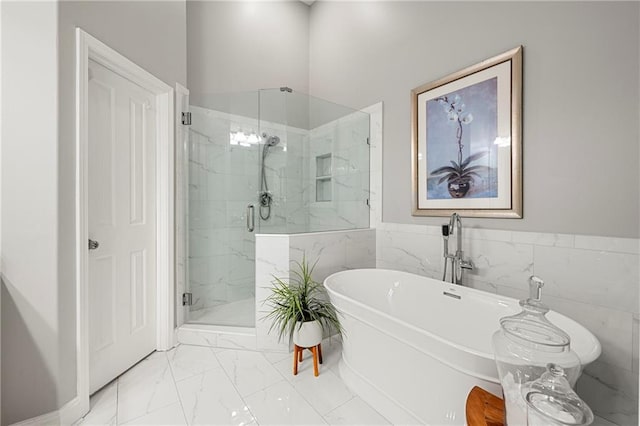 bathroom featuring tile walls and independent shower and bath