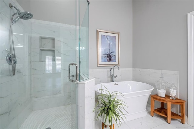 bathroom with shower with separate bathtub and tile walls