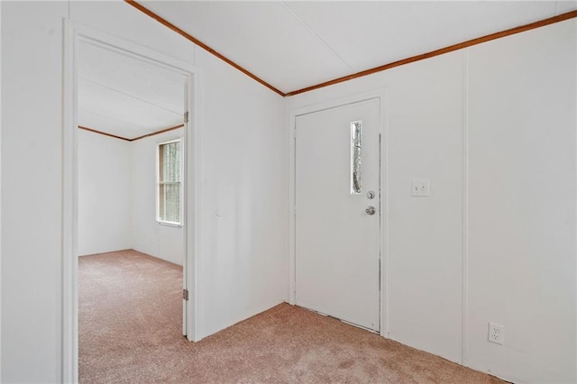 foyer featuring crown molding and light colored carpet