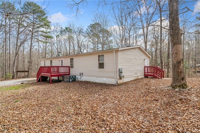 manufactured / mobile home with cooling unit and a wooden deck