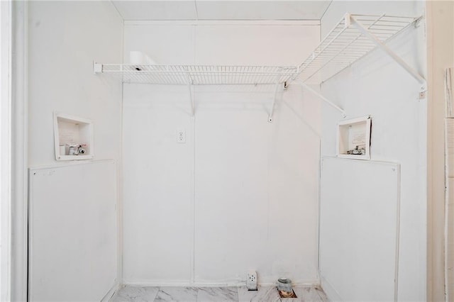 clothes washing area featuring marble finish floor and washer hookup