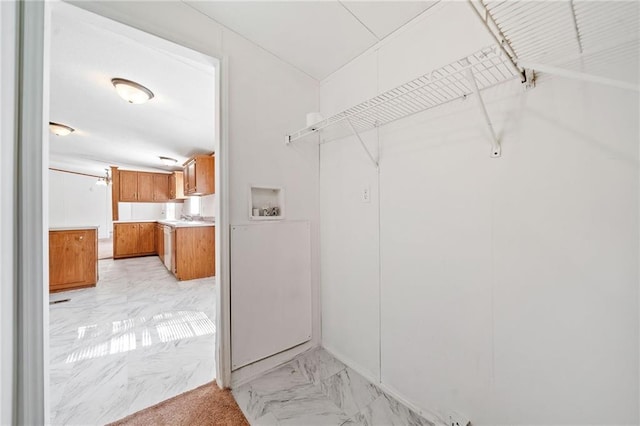 spacious closet featuring marble finish floor