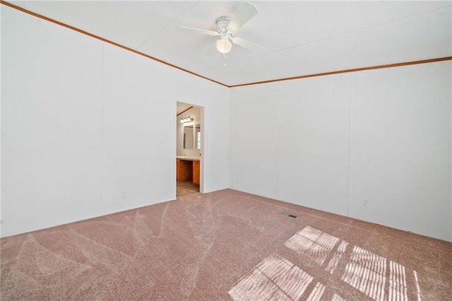 spare room with light carpet and a ceiling fan