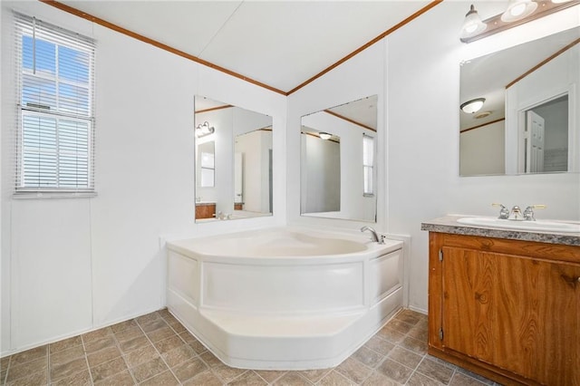 bathroom featuring stone finish flooring, ornamental molding, a bath, and vanity