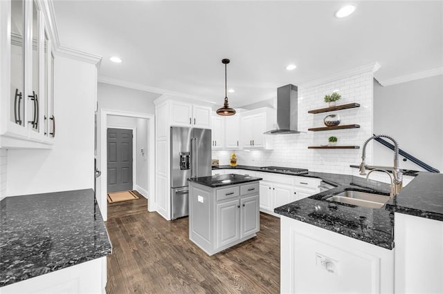 kitchen featuring open shelves, a sink, high quality fridge, gas cooktop, and wall chimney exhaust hood