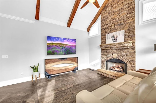 living room featuring beam ceiling, high vaulted ceiling, wood finished floors, and a stone fireplace