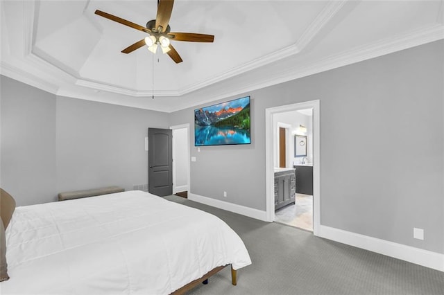 bedroom featuring carpet floors, crown molding, a raised ceiling, connected bathroom, and baseboards