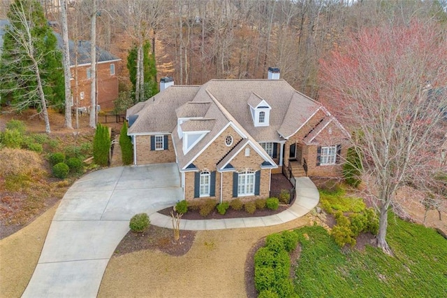 view of front of home featuring driveway and brick siding