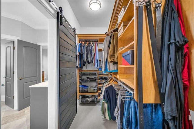 walk in closet featuring a barn door