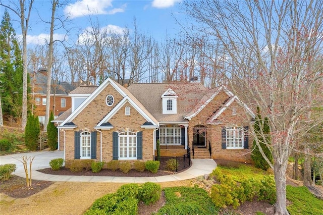 view of front facade featuring concrete driveway and brick siding