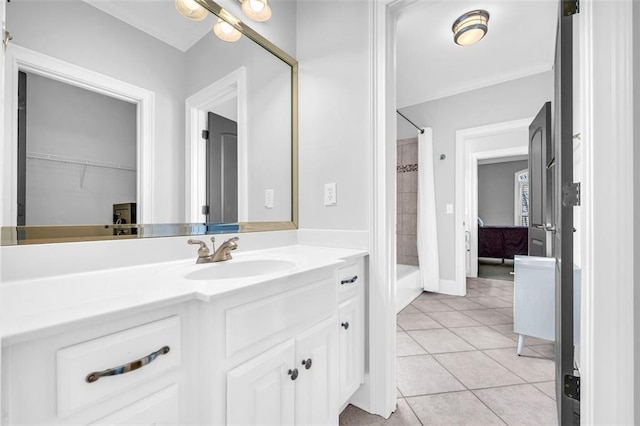 bathroom featuring washtub / shower combination, vanity, and tile patterned floors