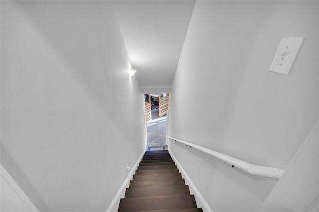 stairway featuring wood finished floors and baseboards