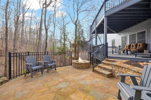 view of patio featuring a deck and a fire pit