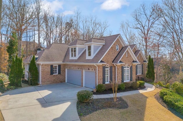 view of front of property featuring a garage, driveway, and brick siding