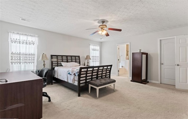 carpeted bedroom featuring ceiling fan, ensuite bath, and a textured ceiling