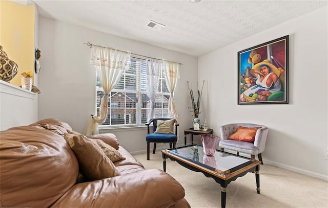 living area with light colored carpet and a textured ceiling