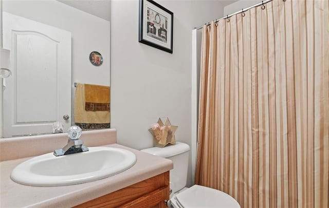 bathroom featuring vanity, a shower with curtain, and toilet