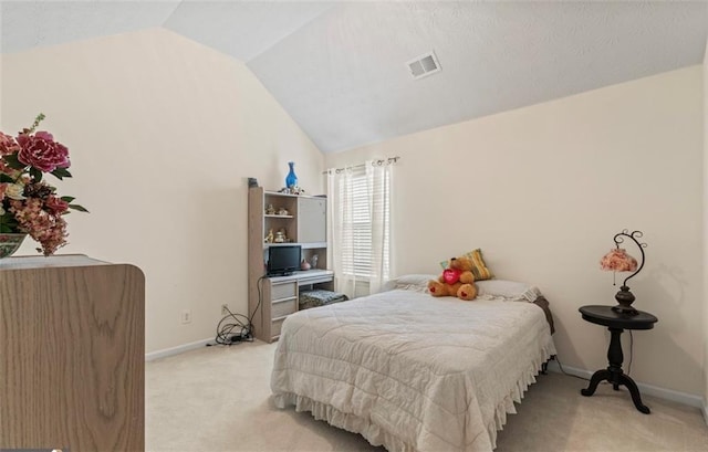 carpeted bedroom with vaulted ceiling