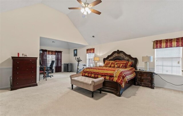 carpeted bedroom featuring multiple windows, ceiling fan, and high vaulted ceiling