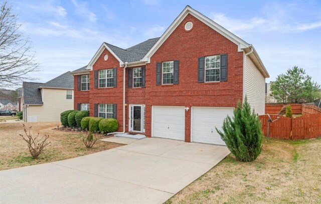 view of front of property featuring a garage and a front lawn