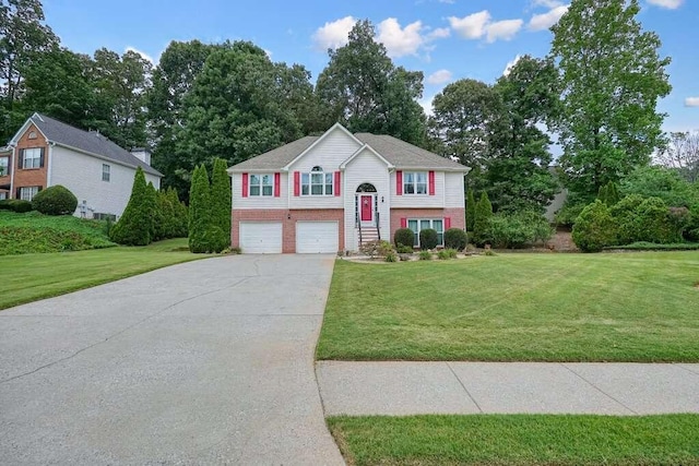 split foyer home with a garage and a front lawn