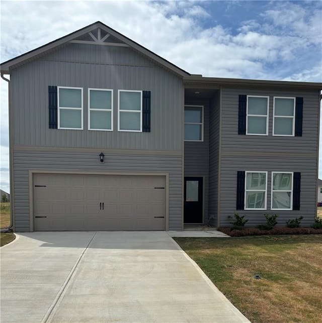 view of front of property featuring a front lawn and a garage