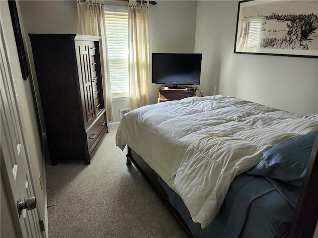 carpeted bedroom featuring multiple windows