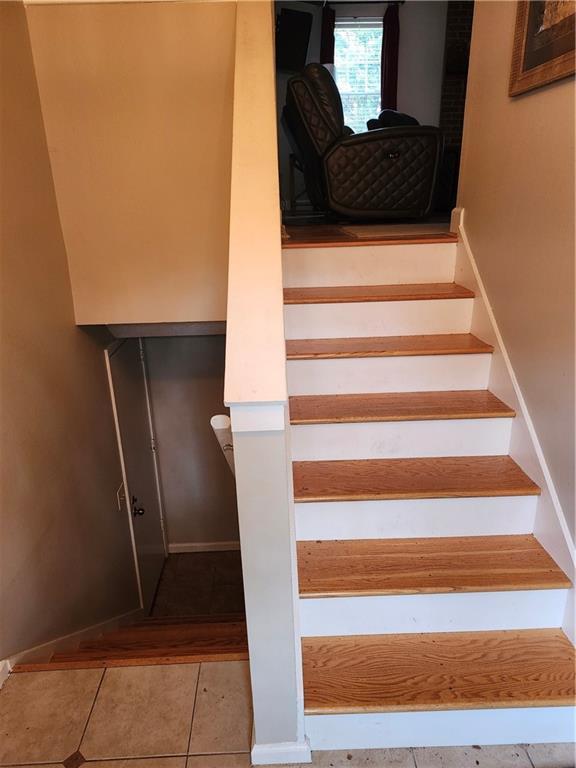 stairway featuring tile patterned floors