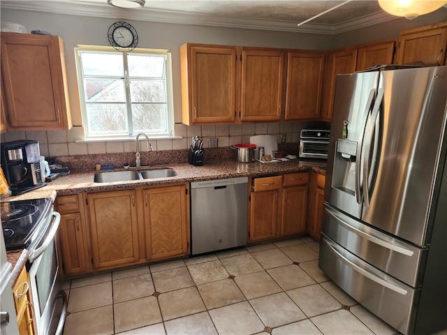 kitchen with crown molding, sink, tasteful backsplash, light tile patterned flooring, and stainless steel appliances