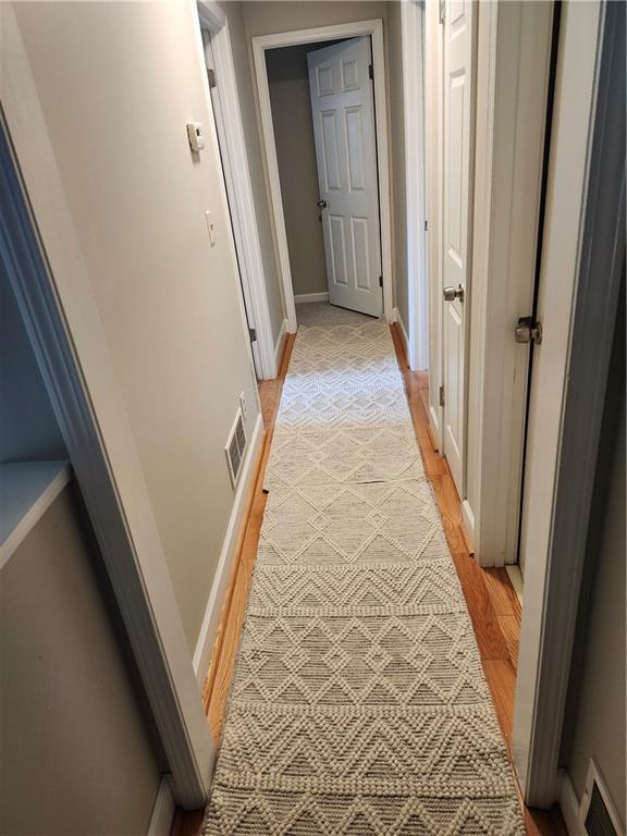 corridor featuring light hardwood / wood-style flooring