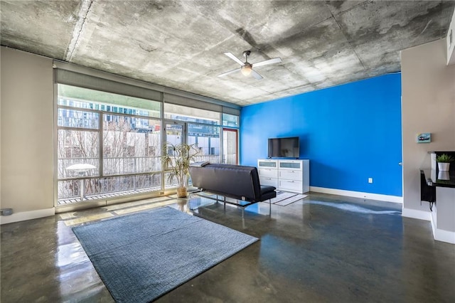 interior space featuring finished concrete flooring, a wealth of natural light, and baseboards