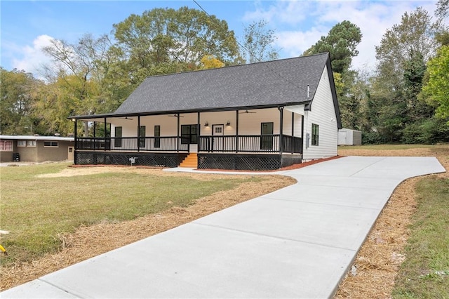 view of front of property with covered porch and a front yard