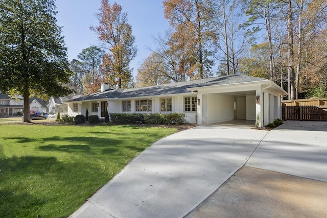 ranch-style house featuring a carport and a front lawn